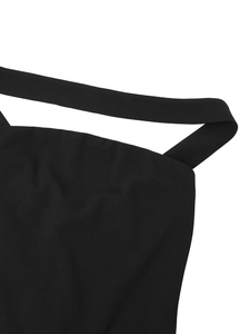 Detailed macro view of the black tube dress neckline with smooth fabric and neat stitching