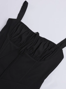 Detail of black corset dress featuring ruched chest design and tie-up front details