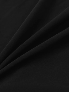 Close-up of black strapless dress fabric showing fine texture and glossy woven finish