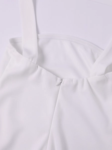 Detail of white dress featuring invisible zipper closure and wide shoulder strap stitching