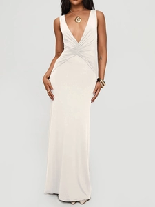 Detail of the deep V-neck and ruched waist on a cream sleeveless fishtail maxi dress