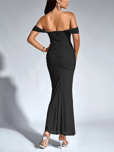 Detail of the back ruched design and mermaid hemline on this elegant black evening gown