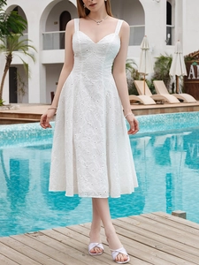 Detail of white V-neck midi dress featuring intricate hollow embroidery and lace texture