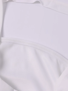 Detail of white strapless dress featuring non-slip silicone strip and fine edge stitching