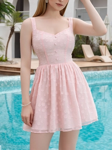 Detail showing the floral texture and decorative buttons on a pink summer dress