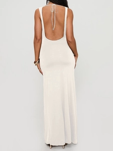Close-up of elegant deep V backless detail with halter tie on a milk silk maxi dress