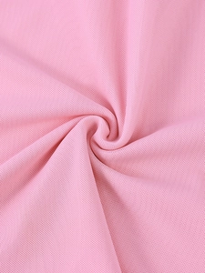 Close-up of soft pink mesh fabric texture showing breathable knitted pattern details