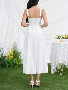 Detail view of the elegant smocked back and adjustable straps on this white maxi dress