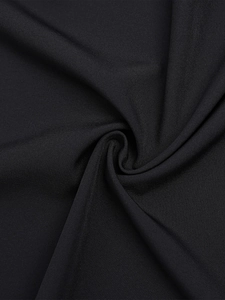 Close-up of black elastic knit fabric showing detailed fine texture and soft drape