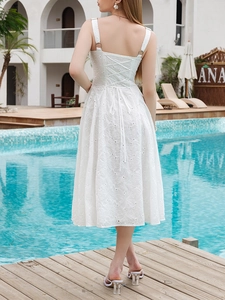 Detailed back view of white eyelet lace midi dress with vintage lace-up ribbon design