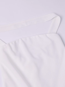 Detail of the white halter neck neckline with fine textured fabric and clean stitching