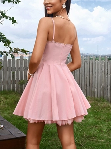Detailed back view of a pink A-line dress featuring a hidden zipper and tiered ruffle hem