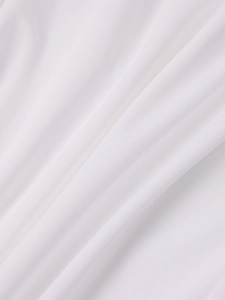 Close-up of high-quality white knitted fabric showing smooth texture and soft drape detail