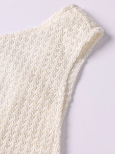 Detail of crochet knit strap showing textured mesh hollow pattern on a summer beach dress