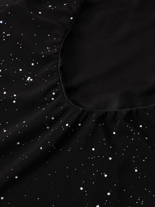 Détail du tissu en mesh noir avec des paillettes argentées scintillantes et bords plissés