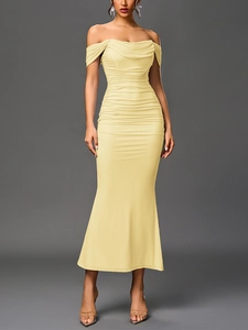 Close-up of elegant pale yellow off-shoulder dress with sophisticated ruched detailing