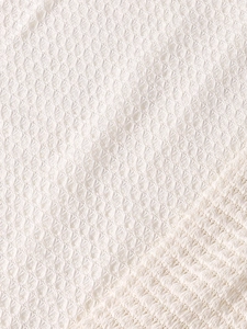Detailed macro view showing the white waffle weave texture and premium knit fabric pattern