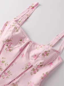 Detailed close-up of pink floral corset top with lace-up hollow stitch and slim straps