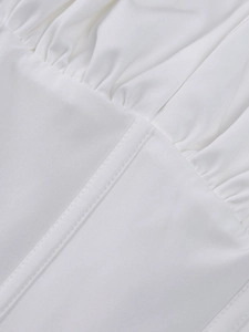 Detail shot of white fishbone dress showing precise stitching and ruched fabric texture
