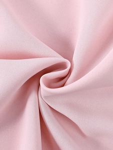 Detailed macro view of soft pink lace and woven fabric texture on a backless mini dress