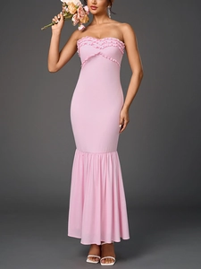 Detailed view of pink tube dress featuring triple-layered ruffles and mermaid hemline