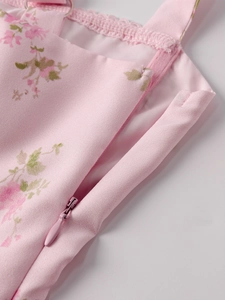 Close-up of pink floral dress featuring invisible zipper and adjustable metal strap rings