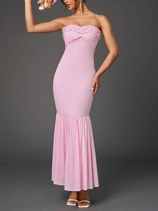Detail of pink strapless mermaid dress with ruffled neckline and tiered pleated hem