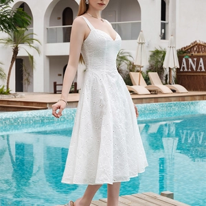 Elegant white eyelet lace midi dress with V-neck and embroidery by the pool