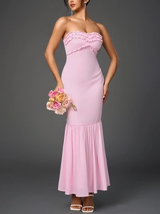 Detail of pink strapless chiffon dress showing ruffled bodice and fisheye hemline