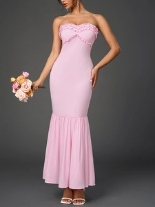 Detail of pink strapless mermaid dress with ruffled bodice and pleated hemline