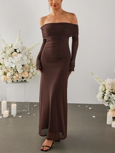 Detail of elegant off-shoulder brown mesh long dress with layered fabric in chic event set