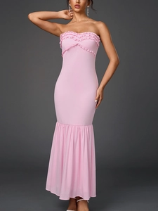 Detail of light pink tube mermaid dress with delicate ruffle layers and slim fit design