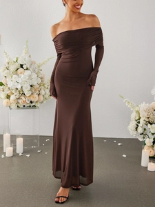 Detail of off-shoulder mesh evening gown with elegant ruching and floor-length mermaid hem