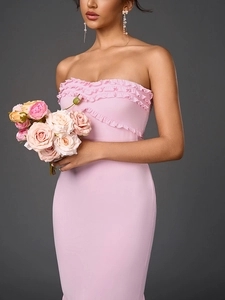 Detail of delicate triple ruffles on the neckline of a pink strapless bodycon party dress