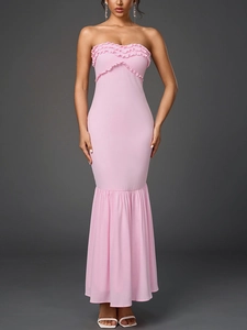 Detail of light pink strapless fishtail dress with triple-layered ruffle trim and pleated hem