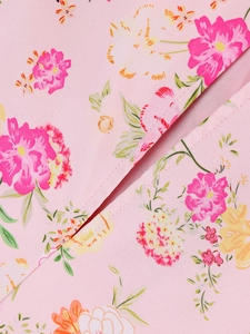 Detailed close-up of smooth stitching and pink floral pattern on a corset maxi dress
