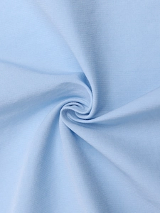 Close-up detail of light blue Tencel fabric showing woven slub texture and draped folds