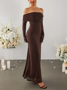 Detail of elegant off-shoulder brown mesh maxi dress with ruched neckline and long sleeves