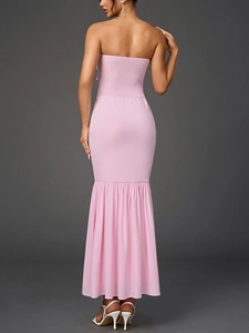 Detail of the back smocking design and mermaid hem on a pink chiffon tube dress