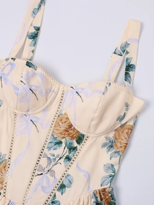 Close-up of vintage floral corset dress with orange roses and delicate lace trim