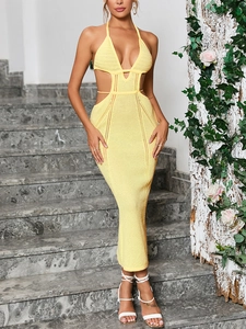 Macro detail of sexy yellow knit dress featuring hollow out waist and halter V-neckline