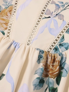 Detailed shot of yellow rose floral print dress with white geometric lace embroidery