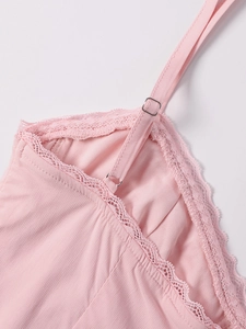 Close-up of pink lace dress showing adjustable thin straps and silver metal buckles