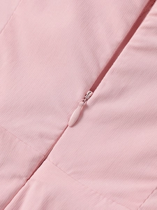 Detail view of a pink dress featuring a high-quality hidden zipper and twill fabric texture