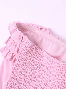 Macro detail of pink smocked chiffon dress with ruffles and anti-slip silicone strip