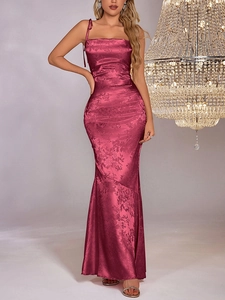 Detailed view of wine red jacquard satin texture and adjustable ribbon straps on gown