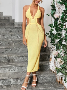 Detail of yellow knit halter dress featuring side cut-outs and intricate hollow textures