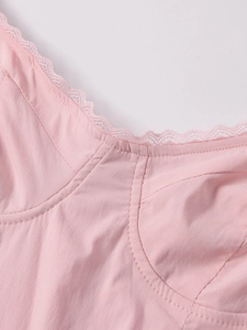 Detail shot of light pink lace trim and vertical stitching on the tencel slip dress