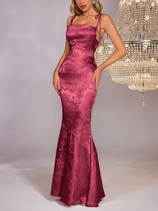 Detail of rose red satin maxi dress featuring elegant floral jacquard and mermaid hem