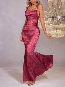 Detailed macro view of the magenta jacquard satin fabric and intricate floral pattern on dress